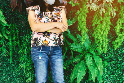 Midsection of woman holding plant