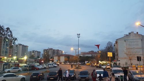 Traffic on city street and buildings against sky