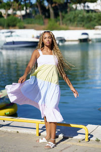 Woman standing on pier at harbor