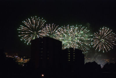 Low angle view of firework display in sky at night