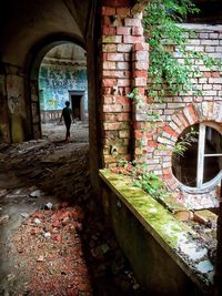 Man and woman walking in corridor of building