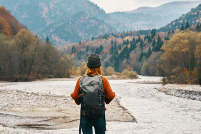 Rear view of man looking at mountains