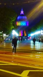 Blurred motion of people walking on road