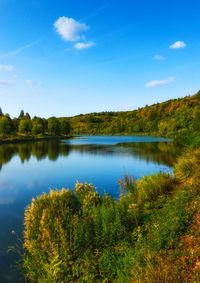 Scenic view of lake against blue sky