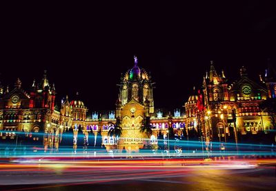 Light trails on building lit up at night