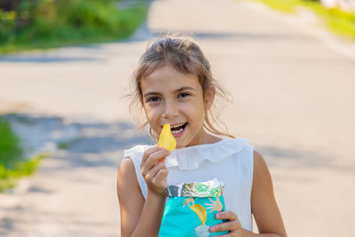 Portrait of girl eating potato chip