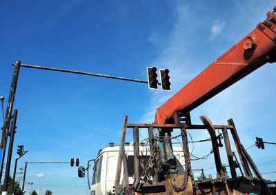 Low angle view of crane against sky