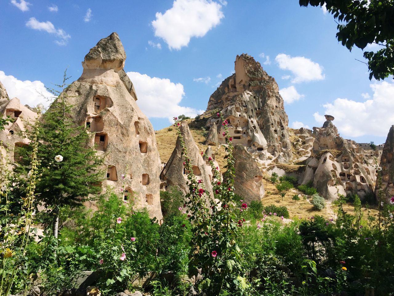 sky, architecture, built structure, plant, history, growth, nature, cloud - sky, day, outdoors, blue, cliff, the past, geology, green color, no people, rock formation, beauty in nature