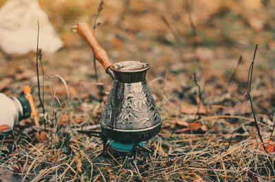 Coffee brewing in metal old turk in autumn forest. rest outside