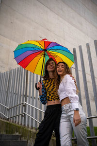 Rear view of woman holding umbrella