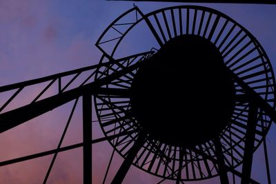 Low angle view of silhouette bridge against sky