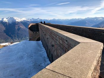 Fortified wall by snow against sky