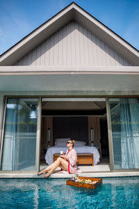 Full length of man relaxing in swimming pool