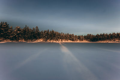 Scenic view of snow covered land against clear sky