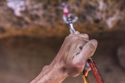 Close-up view of hand of a climber holding a safety rope