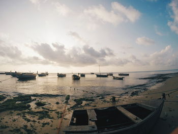 Boats moored on sea against sky