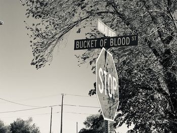 Low angle view of road sign against sky