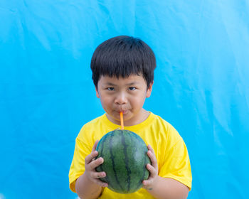 Portrait of boy holding ice cream in swimming pool