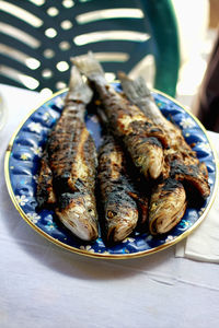 High angle view of grilled fish in plate on table