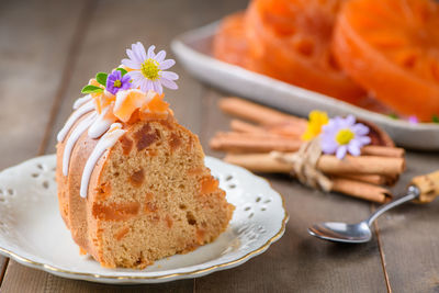 Slice of bael fruit cake decorated with small flowers on top, sweet and healthy dessert, 