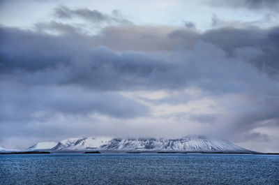 View across breiðafjörður in iceland towards snaefellsnes peninsula with snow-covered mountains 