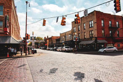 City street and buildings against sky