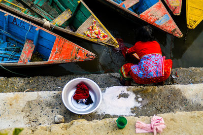 High angle view of woman washing clothes in water