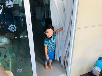 Boy standing at home