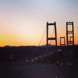 Cars on road at sunset