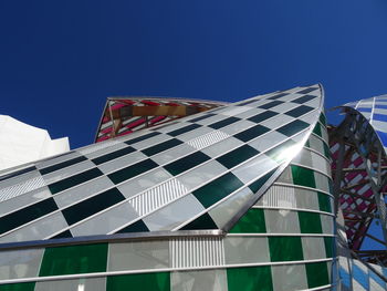 Low angle view of modern building against clear blue sky