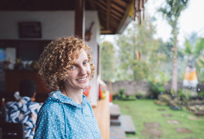 Portrait of smiling young woman standing outdoors