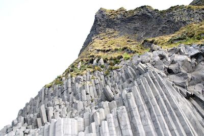 Low angle view of rock formation against clear sky