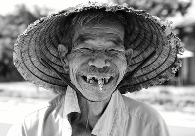 Portrait of smiling man smoking cigarette