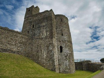 Low angle view of historic building against cloudy sky