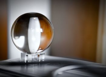 Close-up of crystal ball on table at home