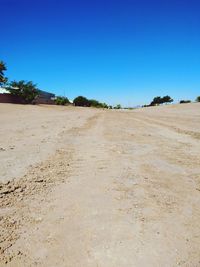 Scenic view of desert against clear blue sky