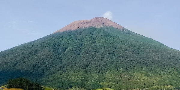 Low angle view of volcanic mountain against sky