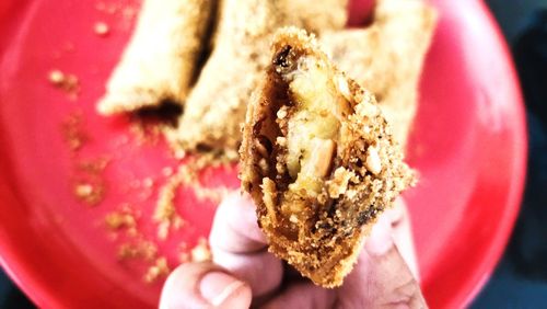 Close-up of hand holding cake