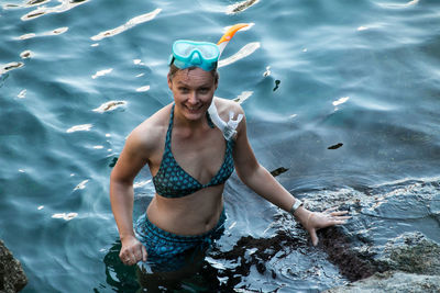 Portrait of smiling man swimming in sea