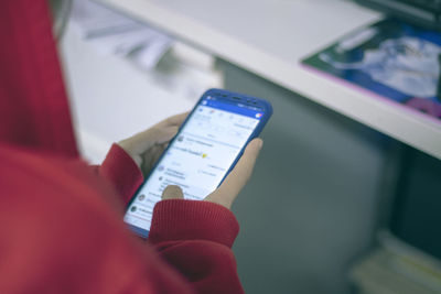 Close-up of hand holding mobile phone