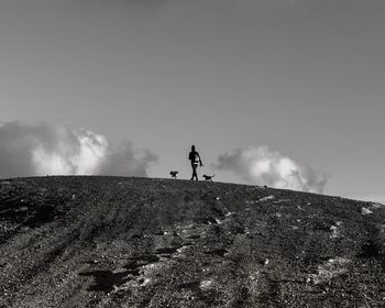 Low angle view of man standing on land against sky