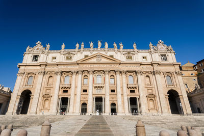 Low angle view of historical building against clear blue sky