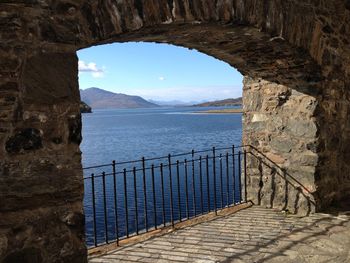 Scenic view of sea seen through arch