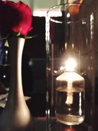 Close-up of lit candle in the dark