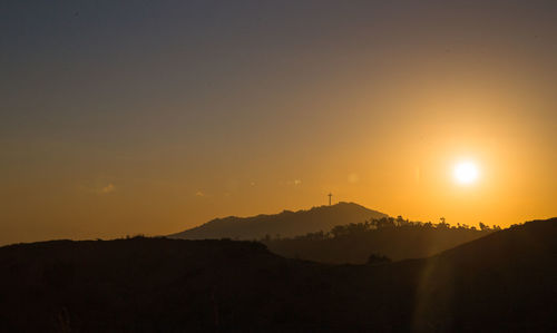 Scenic view of silhouette mountains against sky during sunset