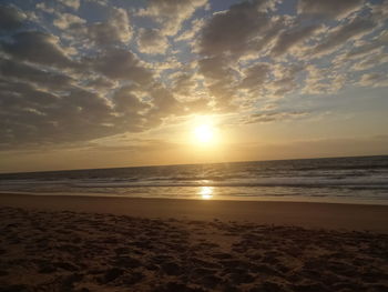 Scenic view of beach against sky during sunset