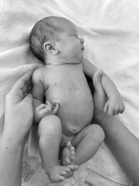 Cute baby girl lying on bed