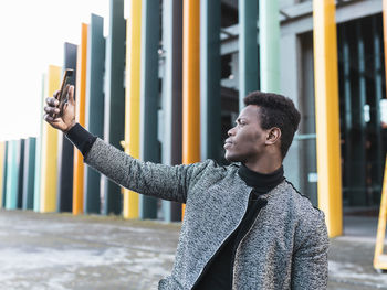 Portrait of elegant young man using phone