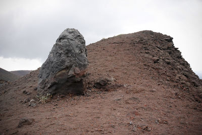 Low angle view of rock formations against sky