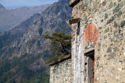 Low angle view of building against mountain range